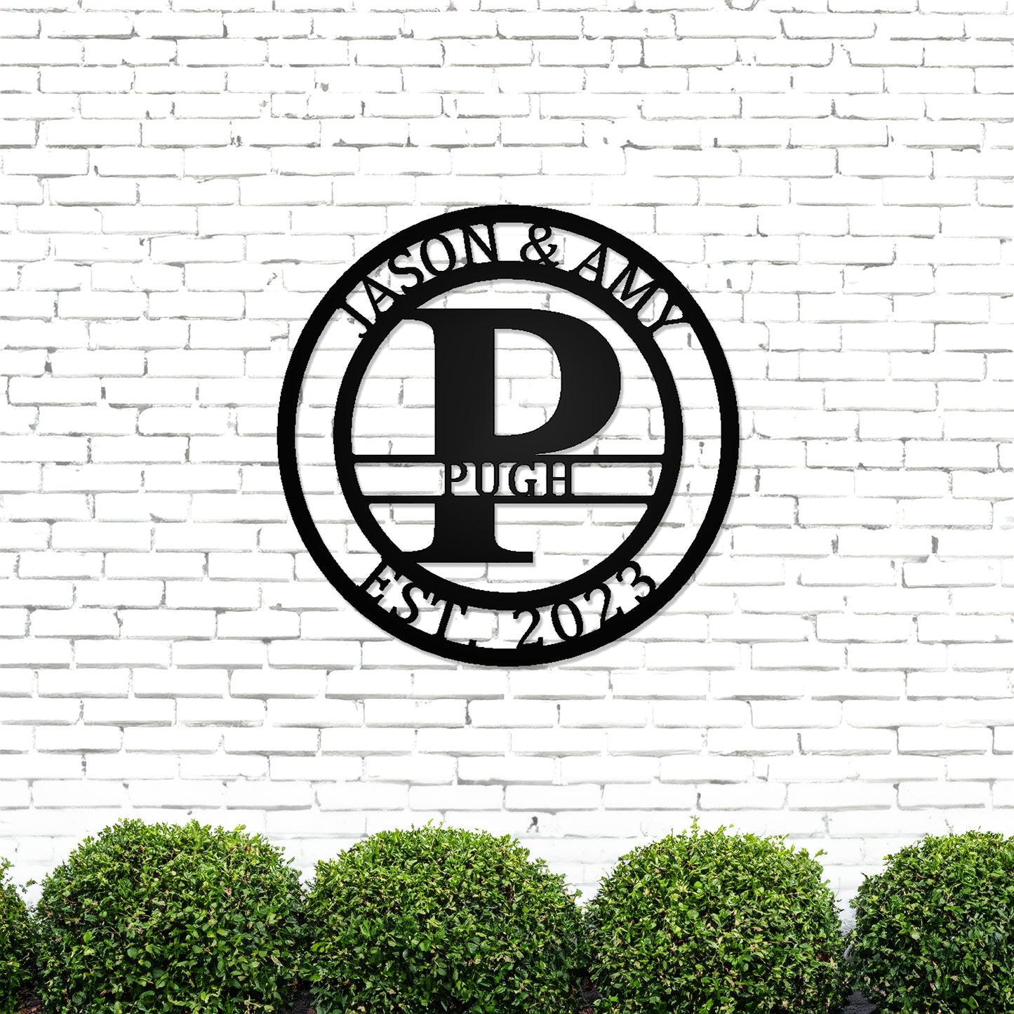 Round Monogram with Top Personalization and EST Date with "JASON & AMY PUGH 2023" personalization on white brick wall