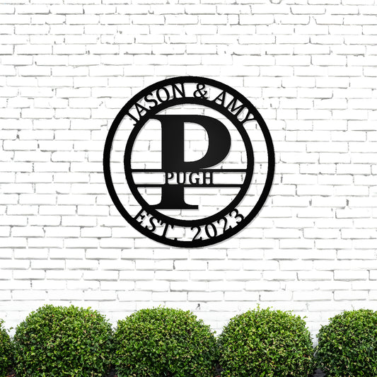Round Monogram with Top Personalization and EST Date with "JASON & AMY PUGH 2023" personalization on white brick wall
