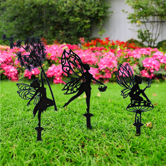 Enchanting Garden Fairies on Stakes shown in a grassy yard with flowers in the background