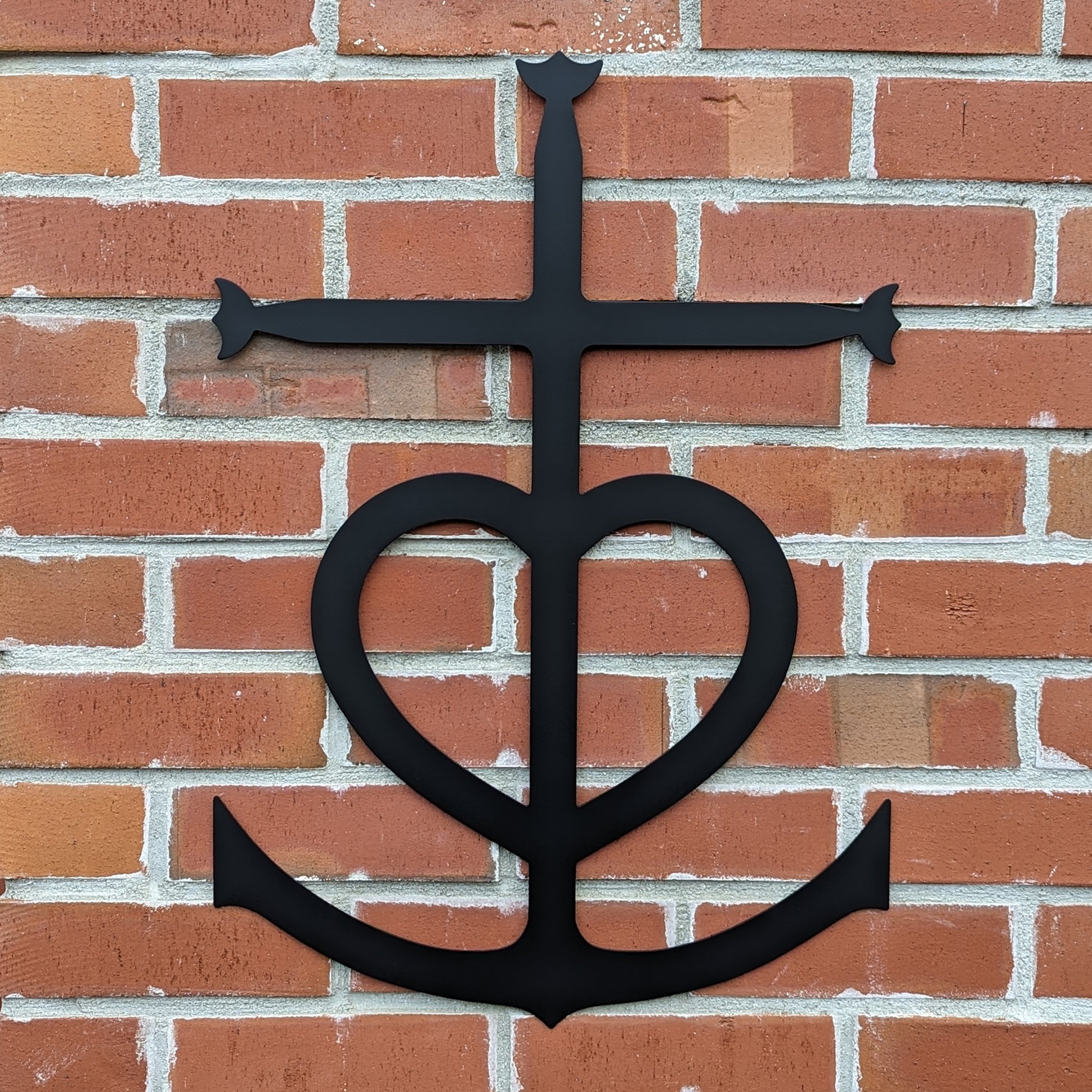 Faith, Hope, Love Metal Sign shown on a brick wall