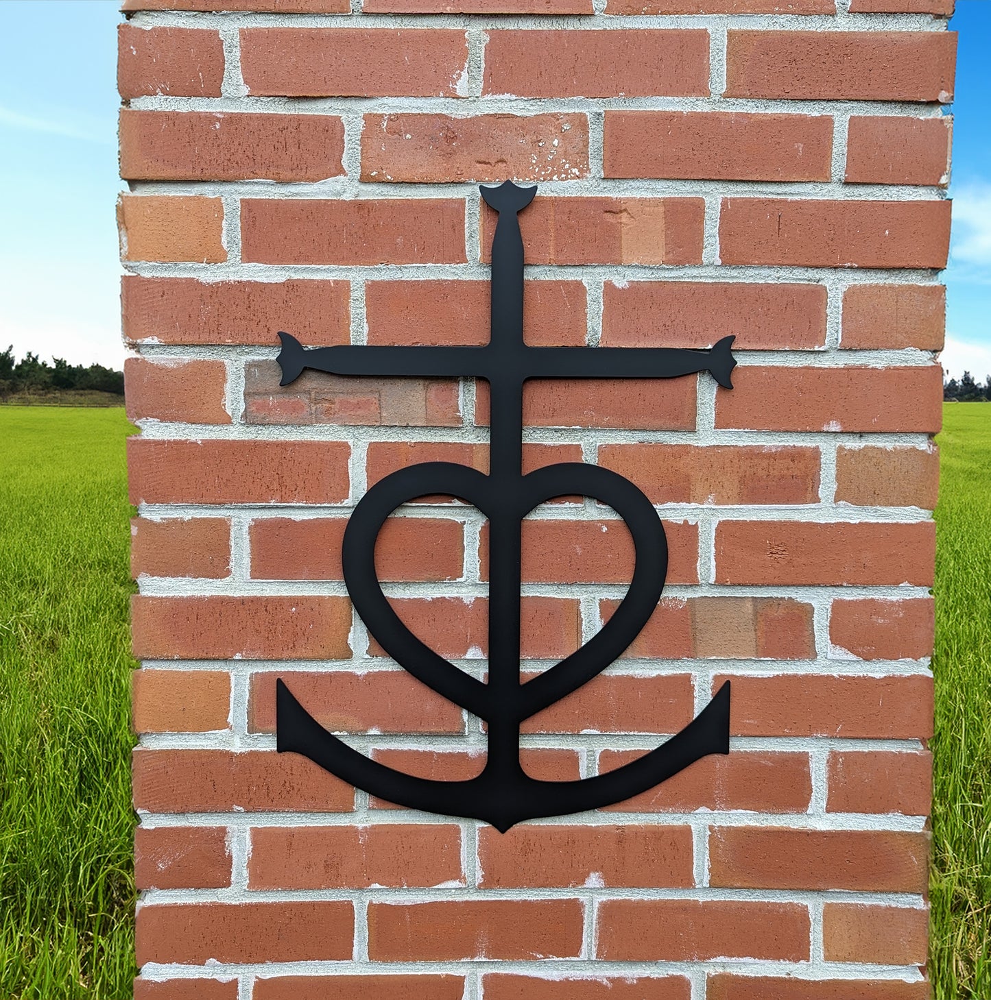 Faith, Hope, Love Metal Sign mounted on a brick pillar