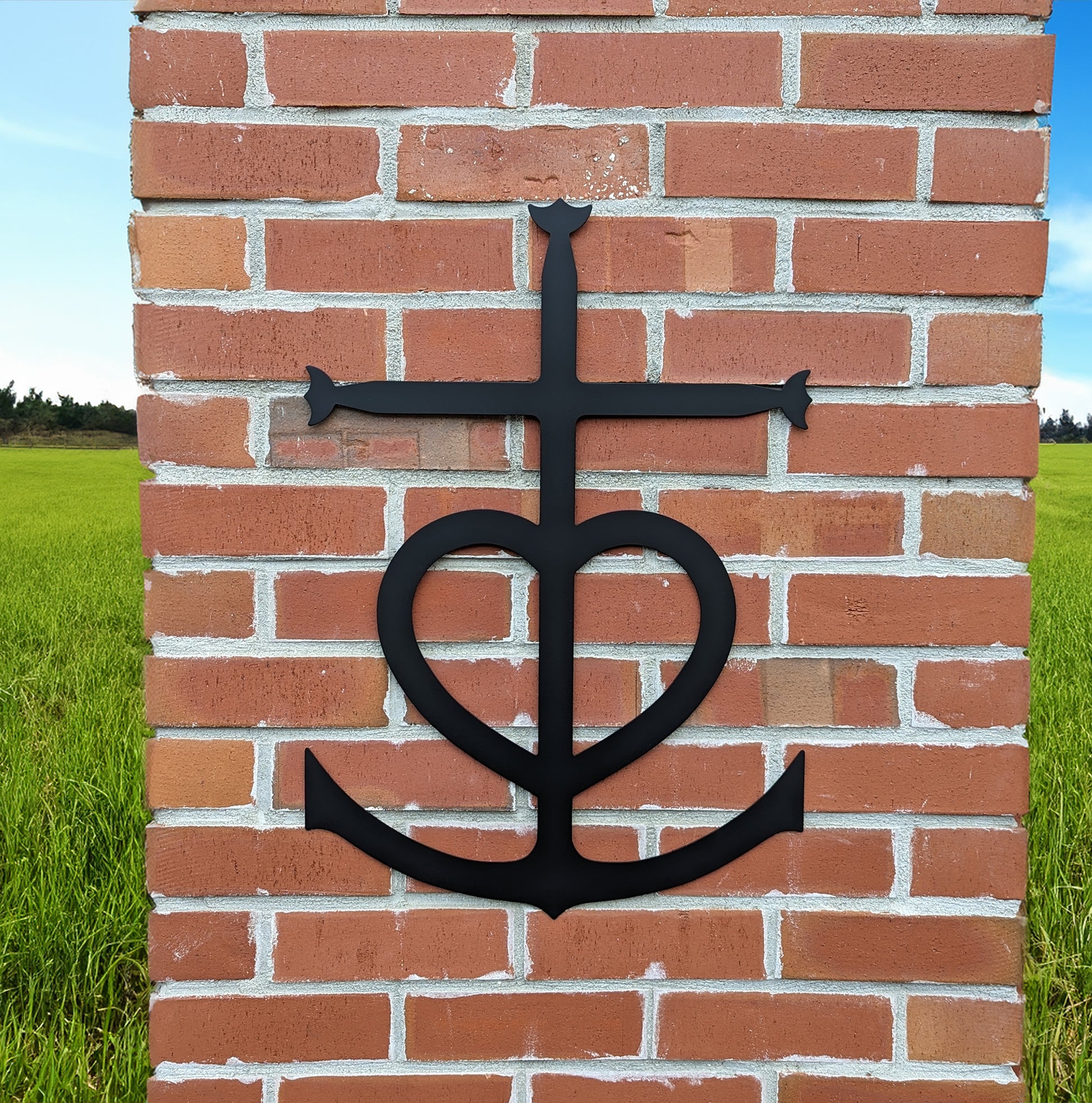 Faith, Hope, Love Metal Sign mounted on a brick pillar