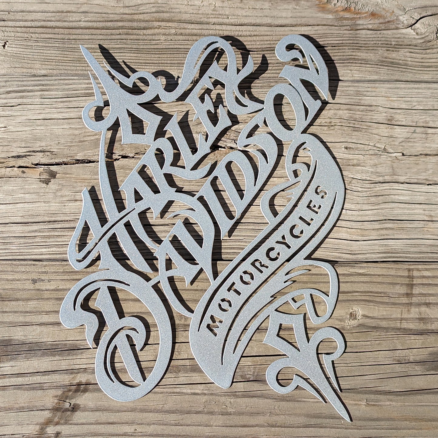 Harley Davidson Rustic Sign Silver shown on a wood plank background