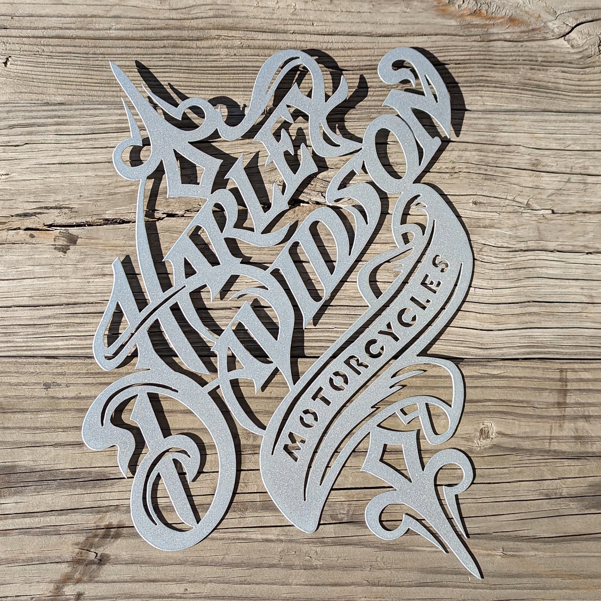 Harley Davidson Rustic Sign Silver shown on a wood plank background