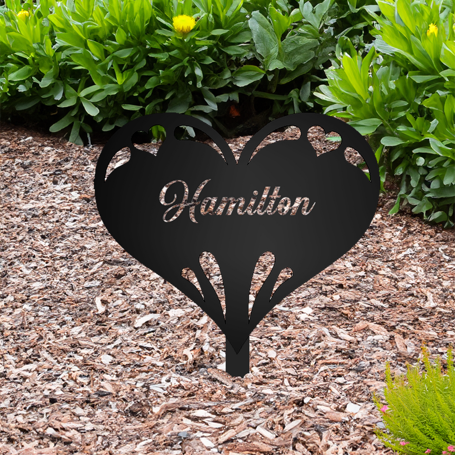 Heart with Personalized Name Garden Sign with "Hamilton" personalization shown in a mulched garden