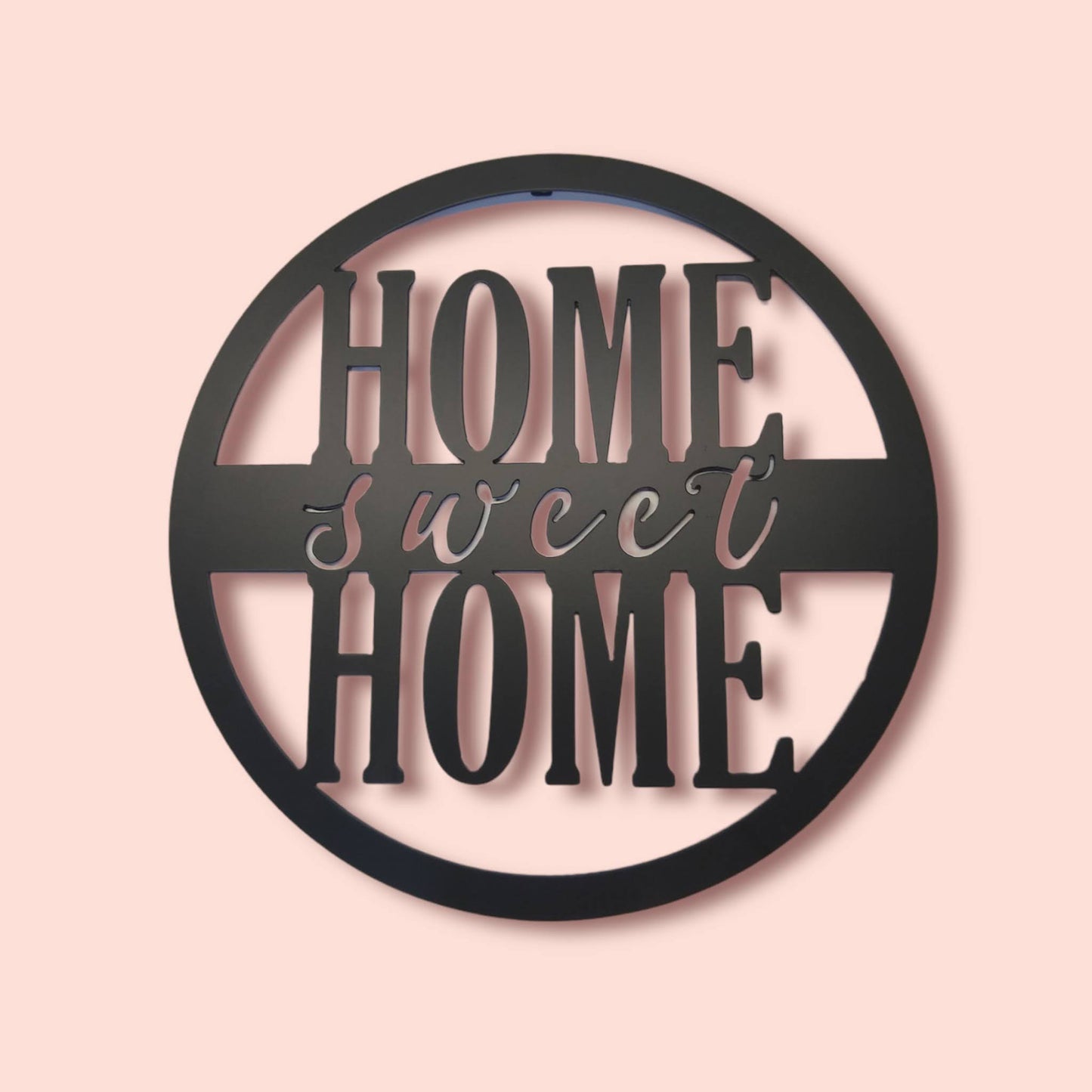 Home Sweet Home Round Metal Sign Script Style on pink background