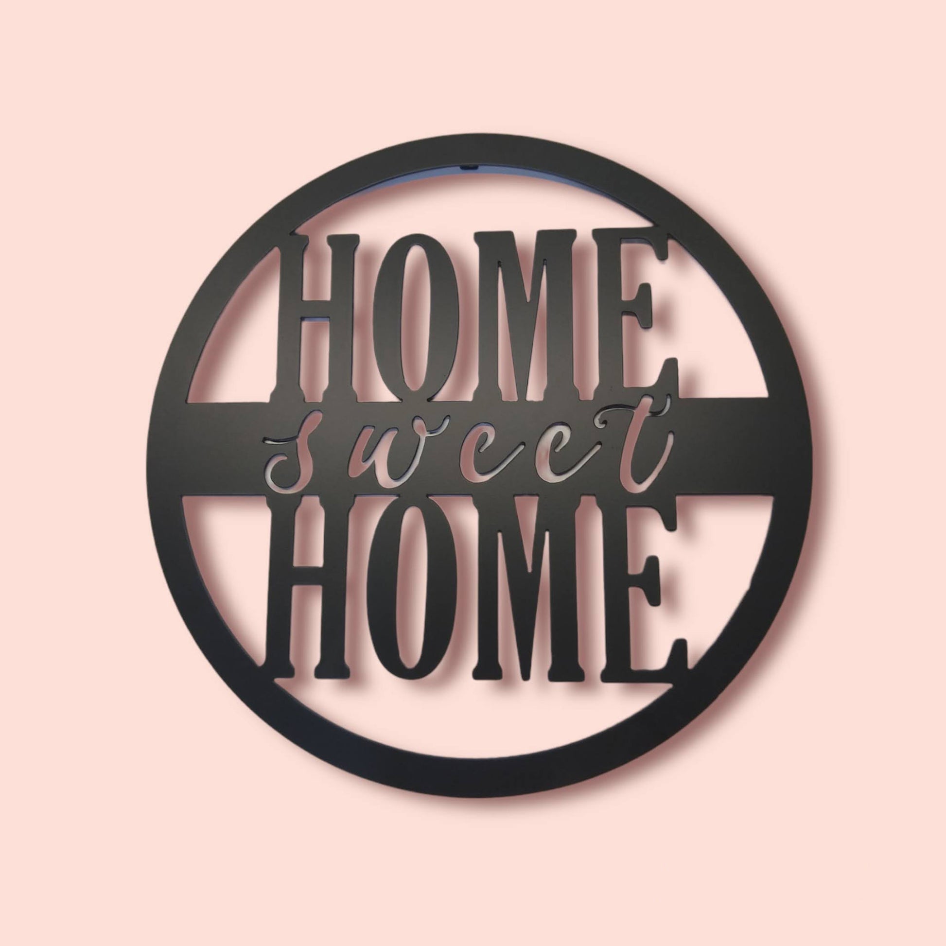 Home Sweet Home Round Metal Sign Script Style on pink background