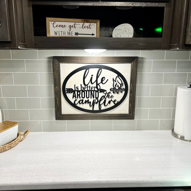 Life is Better Around the Campfire Sign shown framed in a kitchen space in a camper