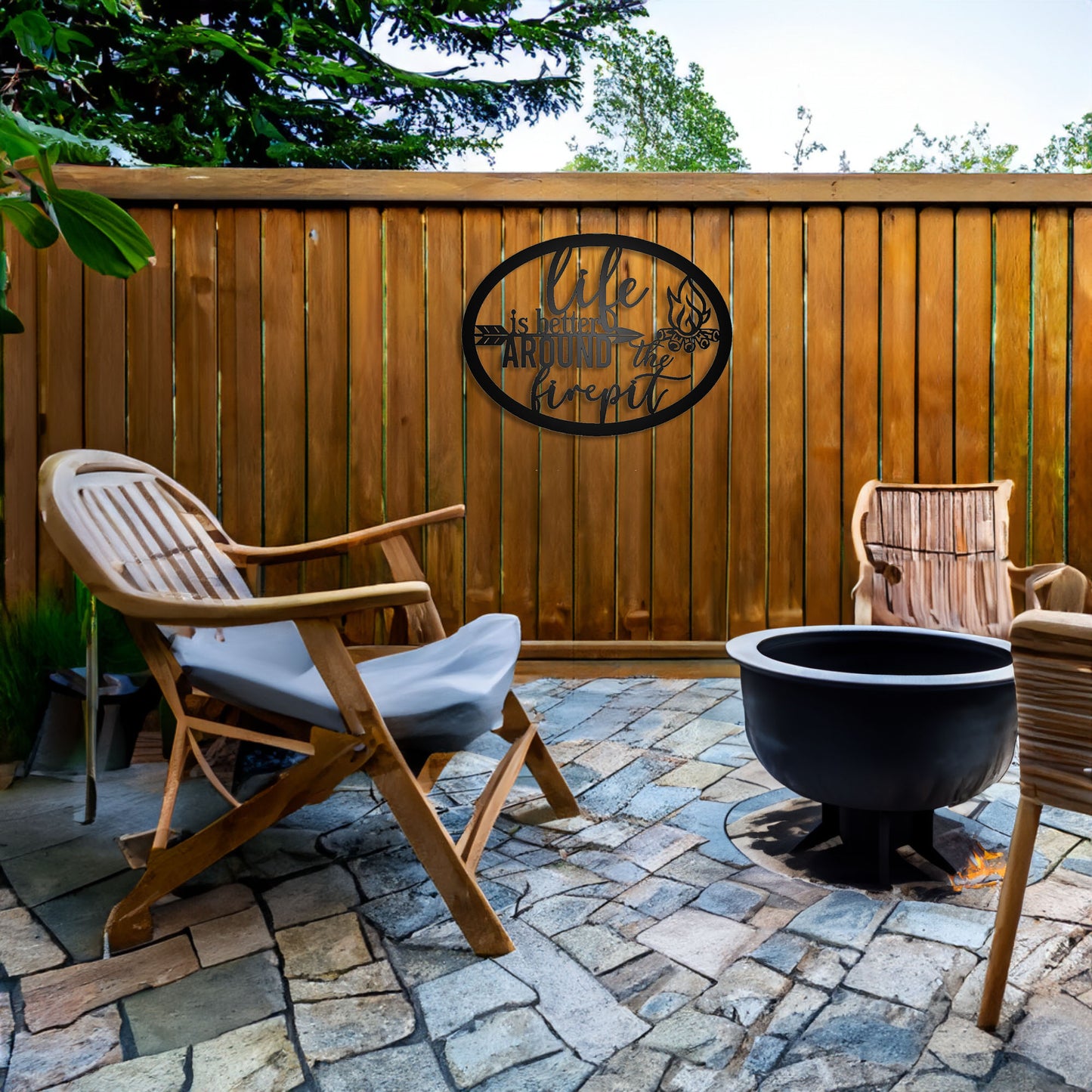Life is Better Around the Fire Pit Metal Sign shown on a patio fence with a firepit
