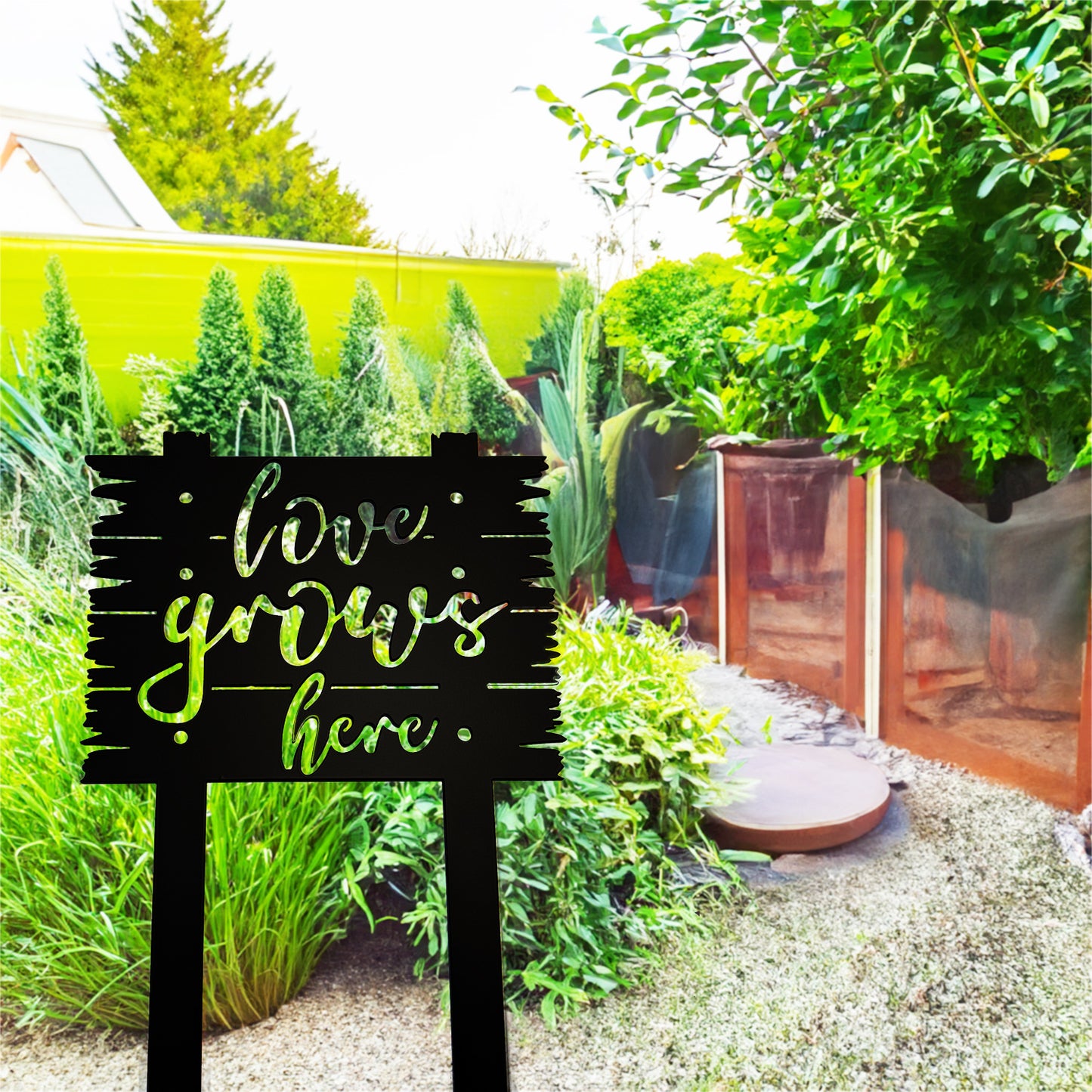 Love Grows Here Sign with Stakes in a small garden