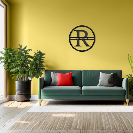 Modern Round Personalized Family Name & Initial Metal Sign with "REYNOLDS" personalization shown on a wall in a living room