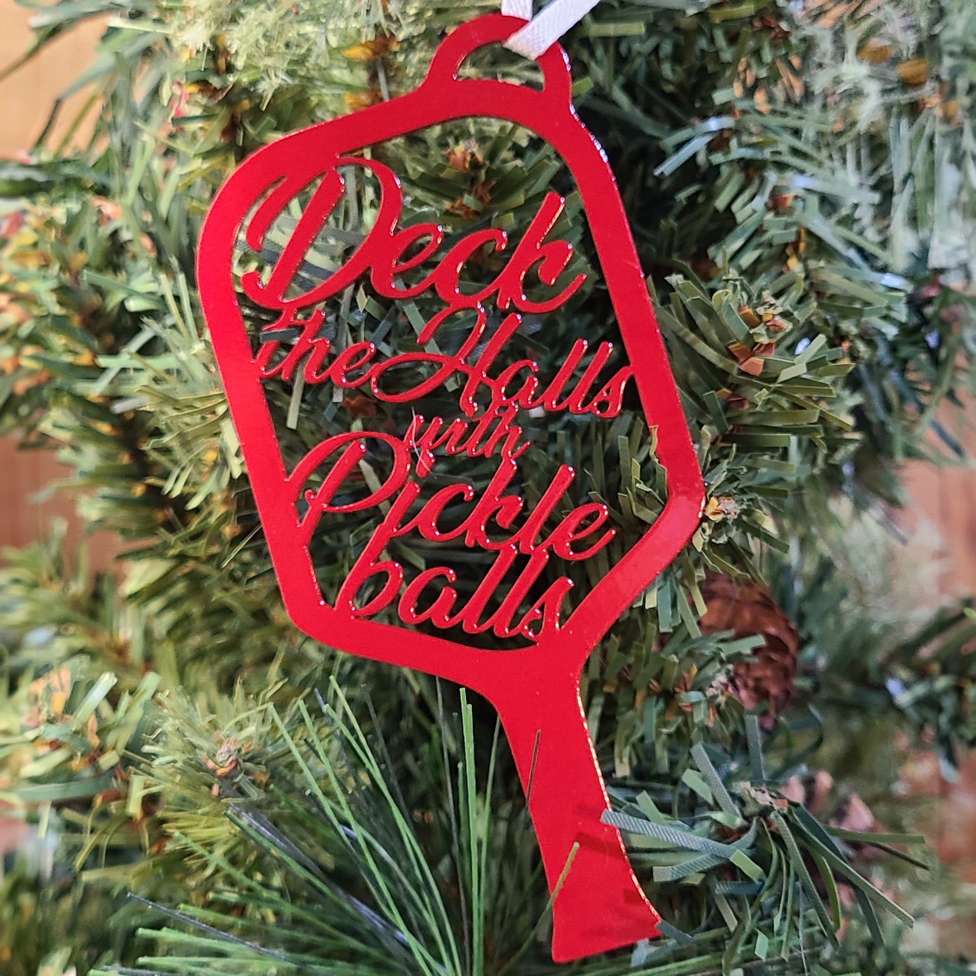 Pickle Ball Metal Holiday Ornament red on Christmas tree
