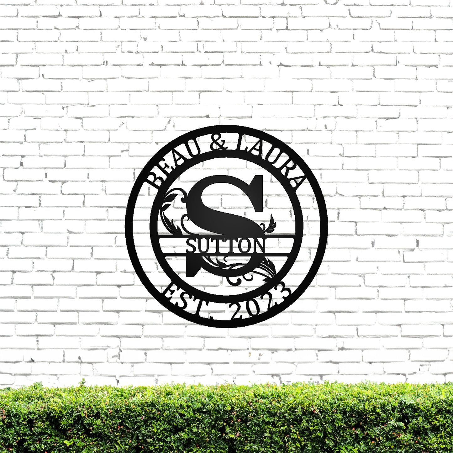 Round Scroll Monogram with Top Personalization and EST Date Black S with "BEAU & LAURA SUTTON 2023" personalization on white brick background