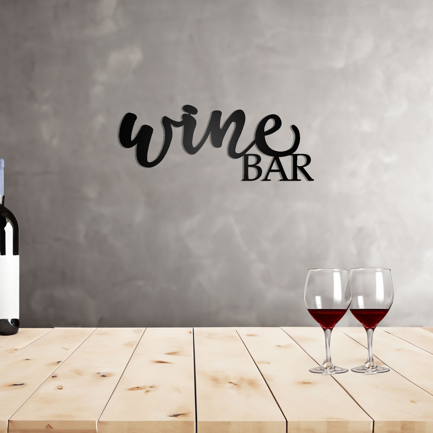 Wine Bar Script Metal Sign on a wall behind a wooden top bar with wine bottle and glasses
