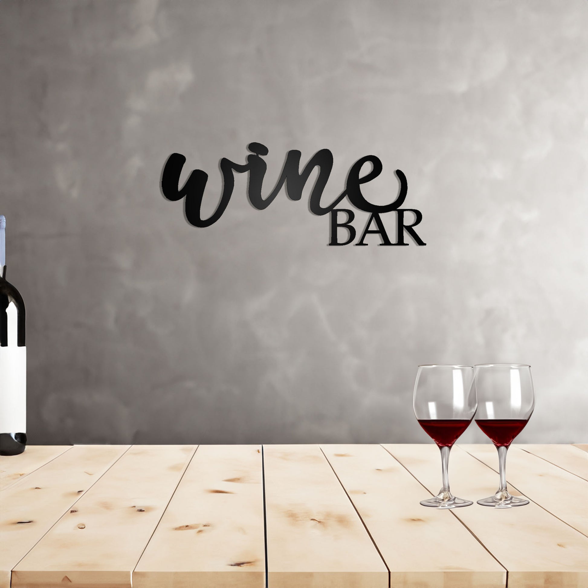 Wine Bar Script Metal Sign on a wall behind a wooden top bar with wine bottle and glasses