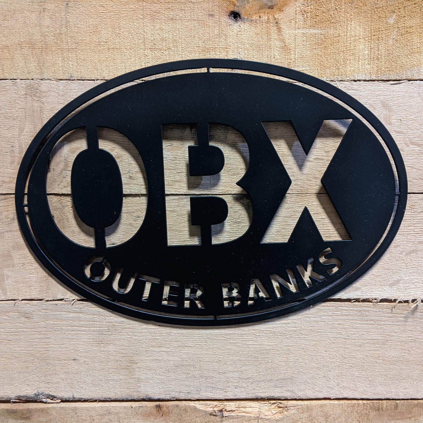 Outer Banks Oval Metal Wall Sign OBX Black - on wood slat
