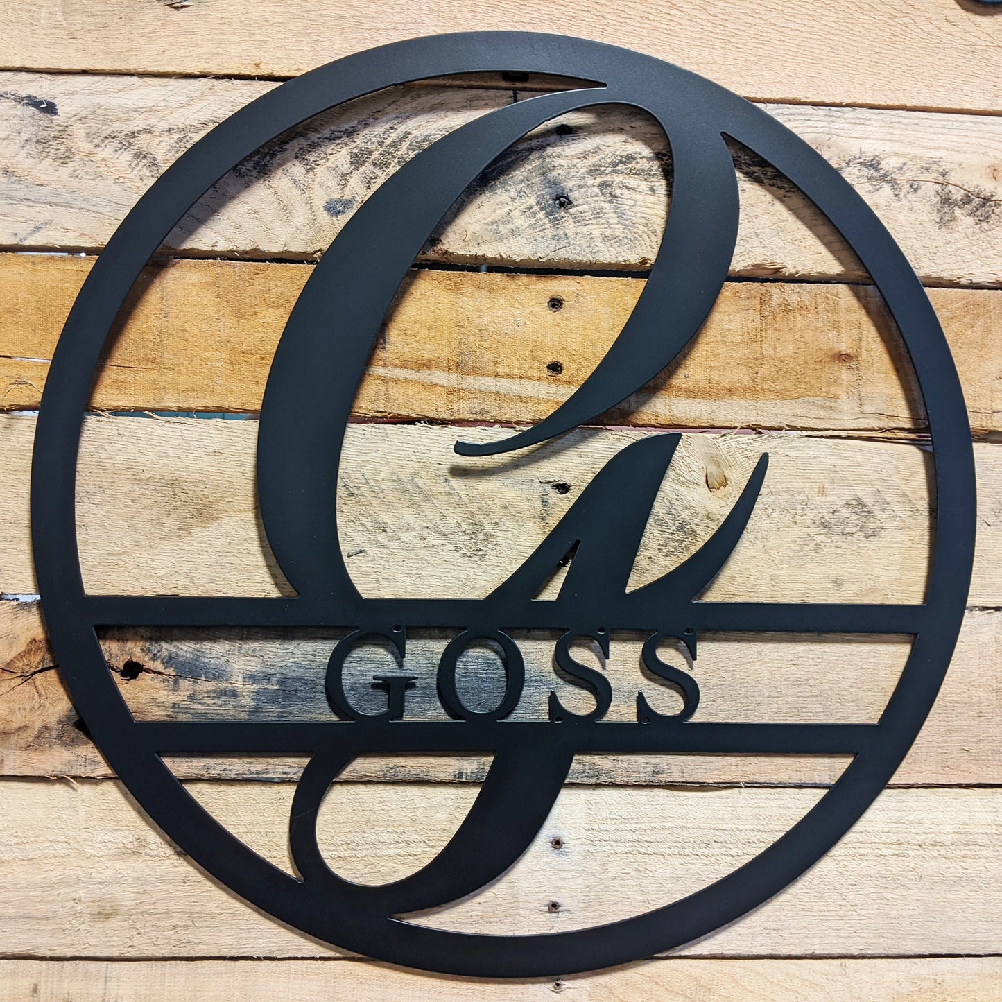 Round Personalized Family Name with Scroll Initial Metal Sign GOSS - on wood