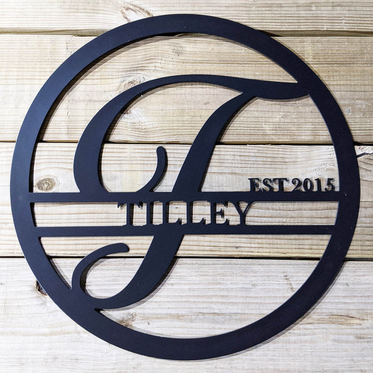 Personalized Round Family Name with Initial & Established Date Metal Sign with "TILLEY 2015" personalization on wood plank background