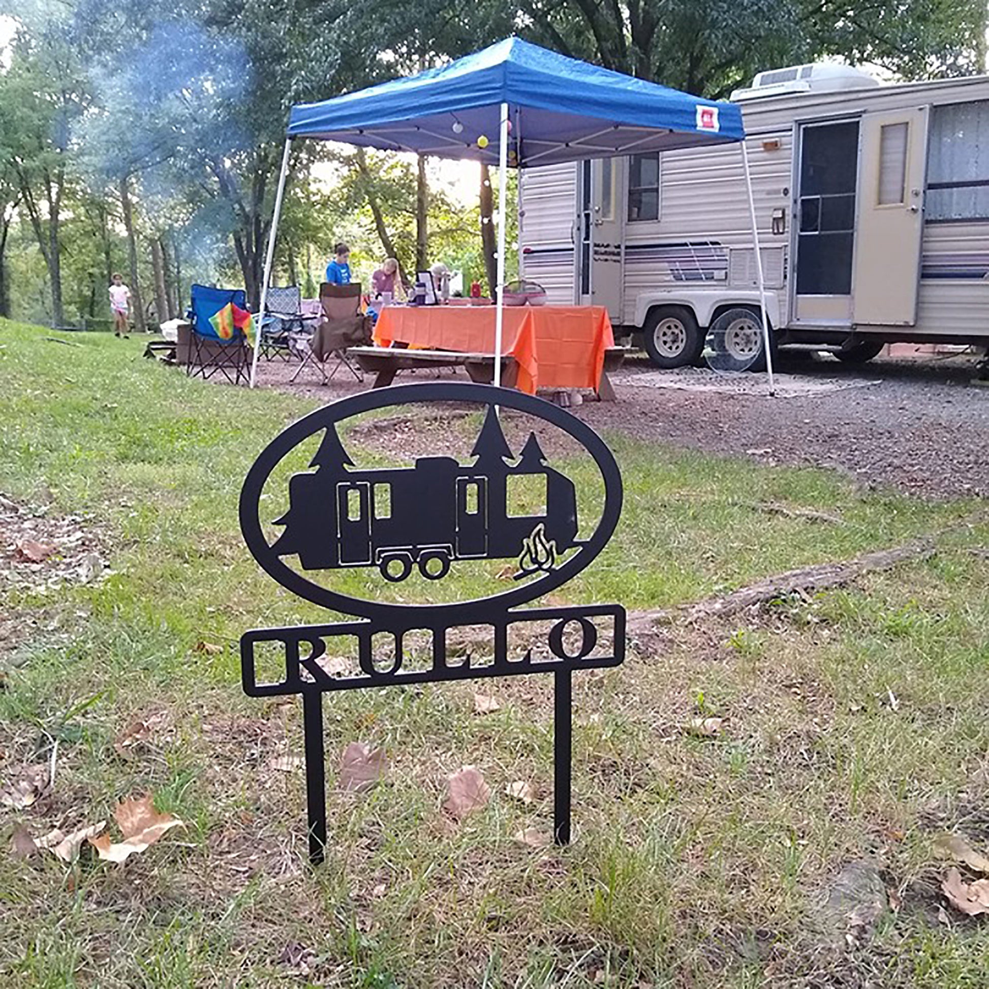 Travel Trailer with Personalized Name Metal Sign - RULLO at campsite