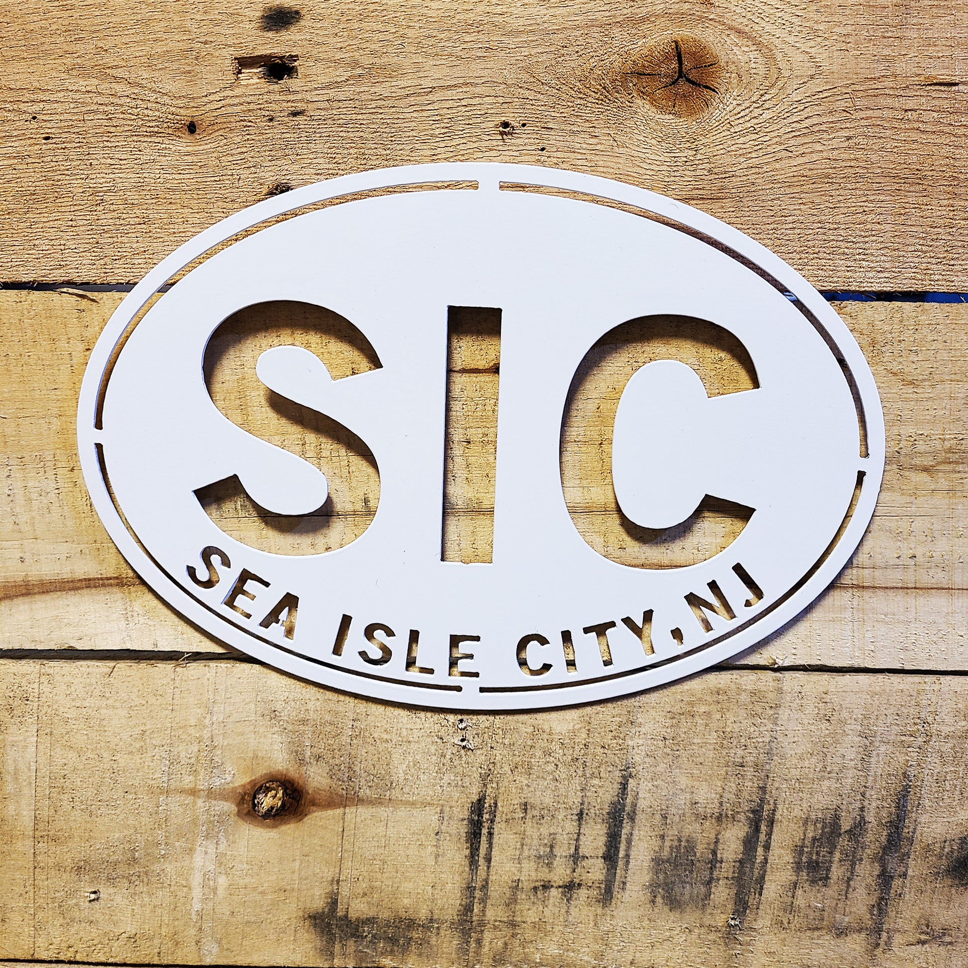 Sea Isle City New Jersey Oval Metal Wall Sign White with wood plank background