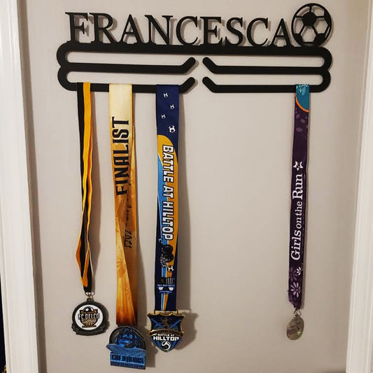 Personalized Soccer Medal Hanger with medals on a bedroom wall