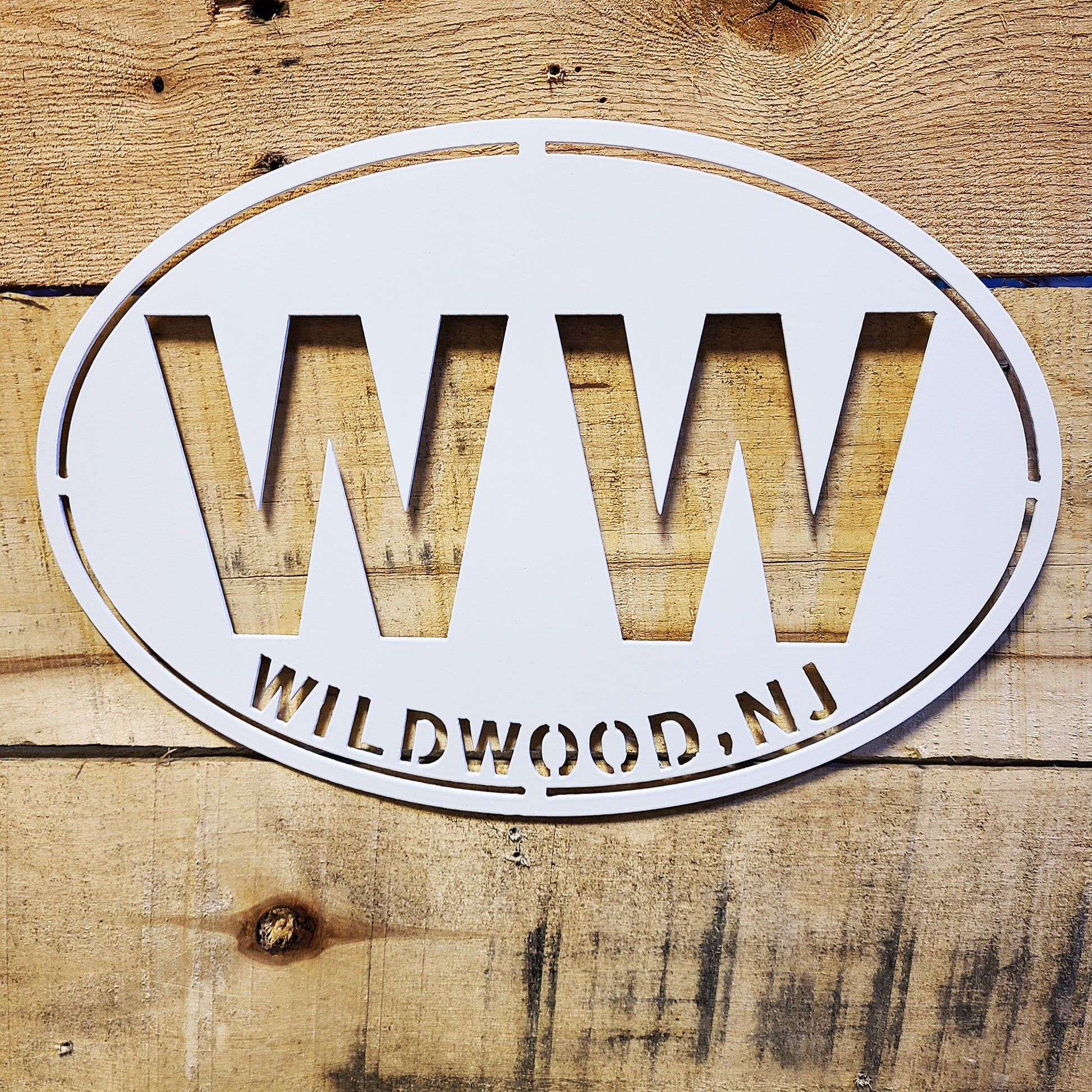 Wildwood New Jersey WW Oval Metal Wall Sign White on wood plank background