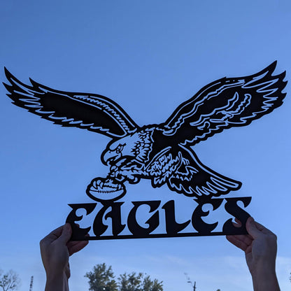 Old School Eagles Logo Black Metal Sign with sky in background