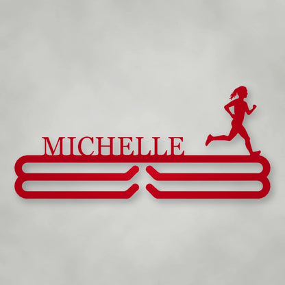 Personalized Female Runner Silhouette Medal Hanger shown in Gloss Red powder coat finish.