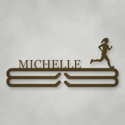 Personalized Female Runner Silhouette Medal Hanger shown in Metallic Bronze powder coat finish.