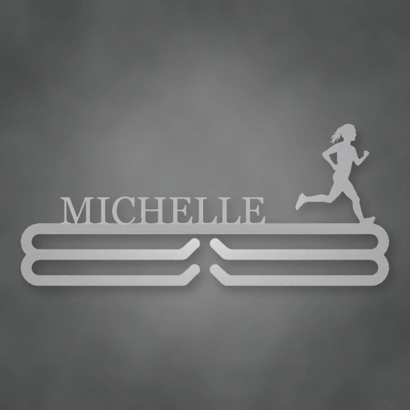 Personalized Female Runner Silhouette Medal Hanger shown in Metallic Silver powder coat finish.